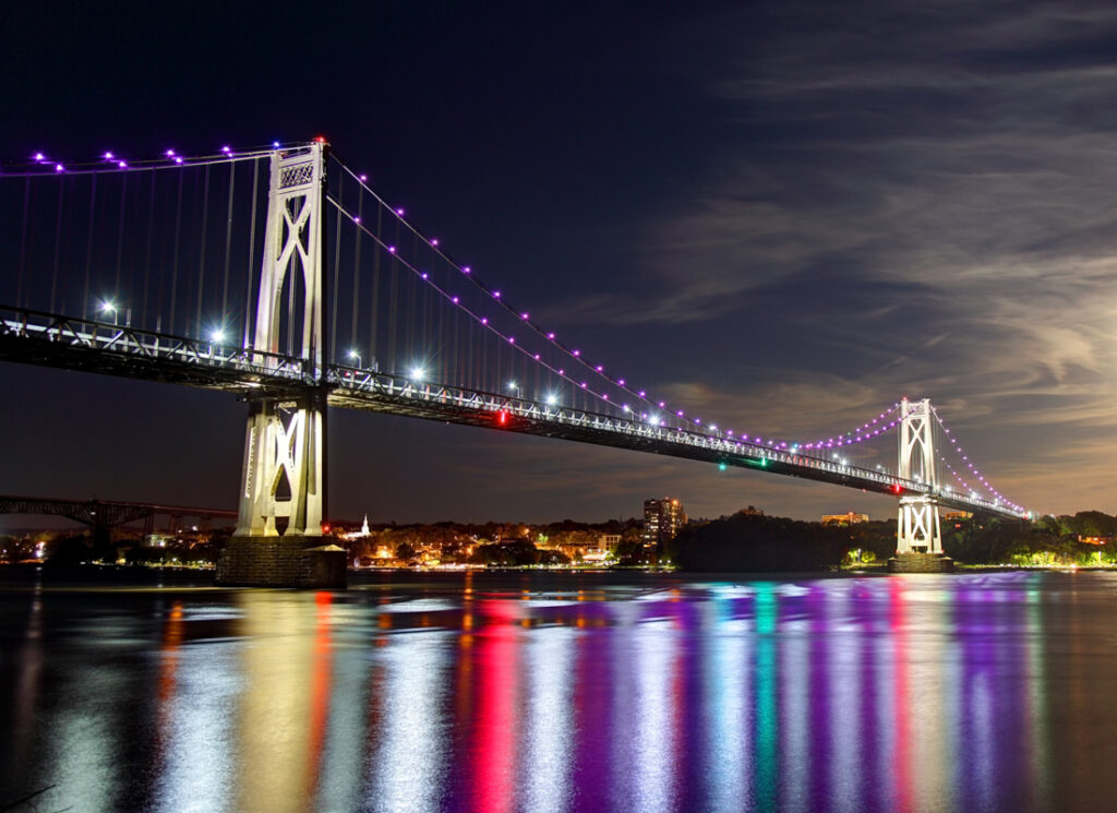 Mid-Hudson Bridge on night with lights reflecting on river