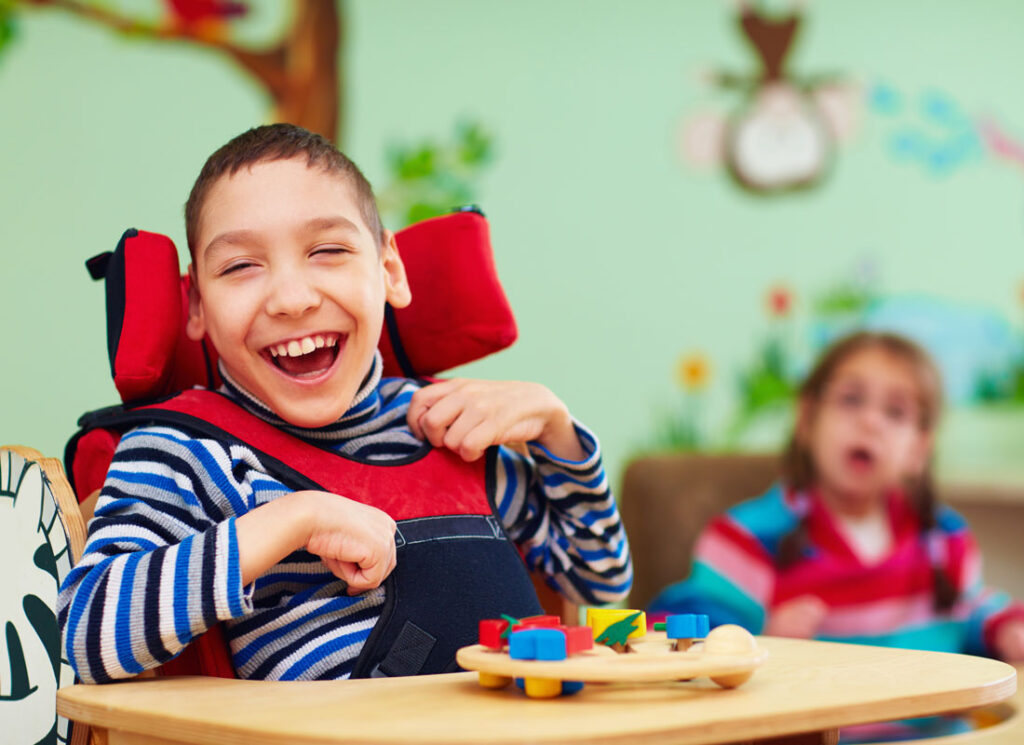 Young boy in red wheelchair