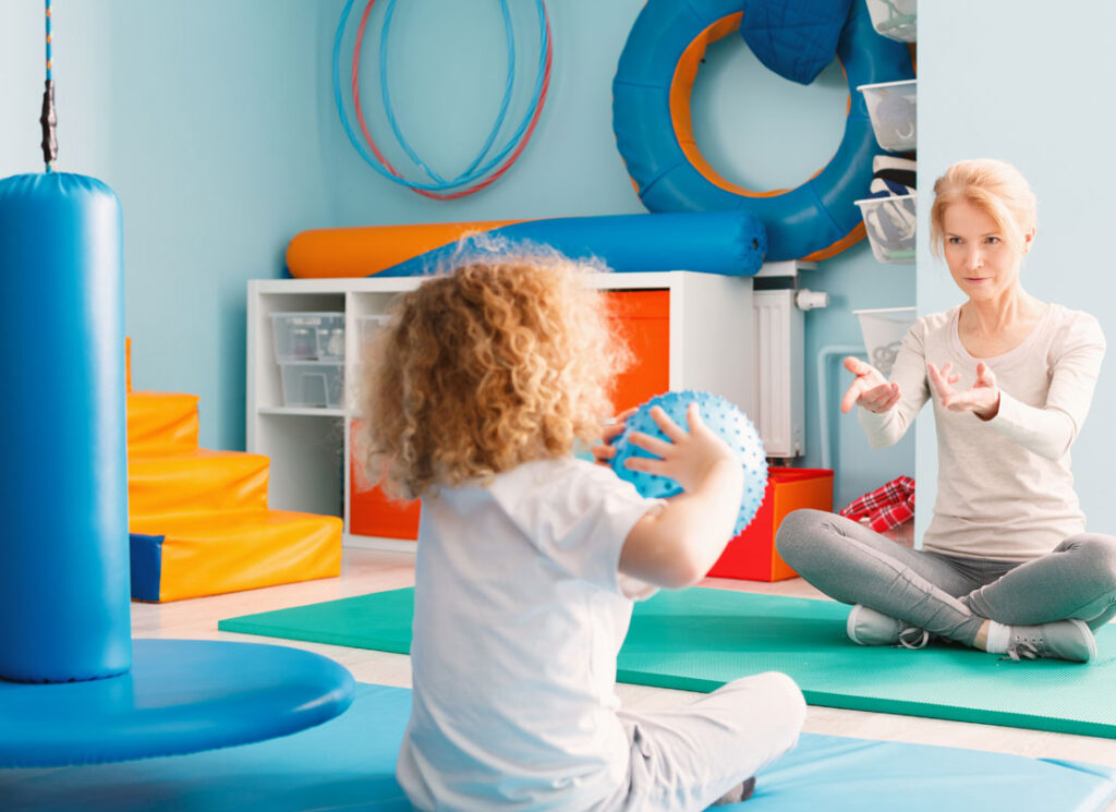 child playing with adult in colorful room