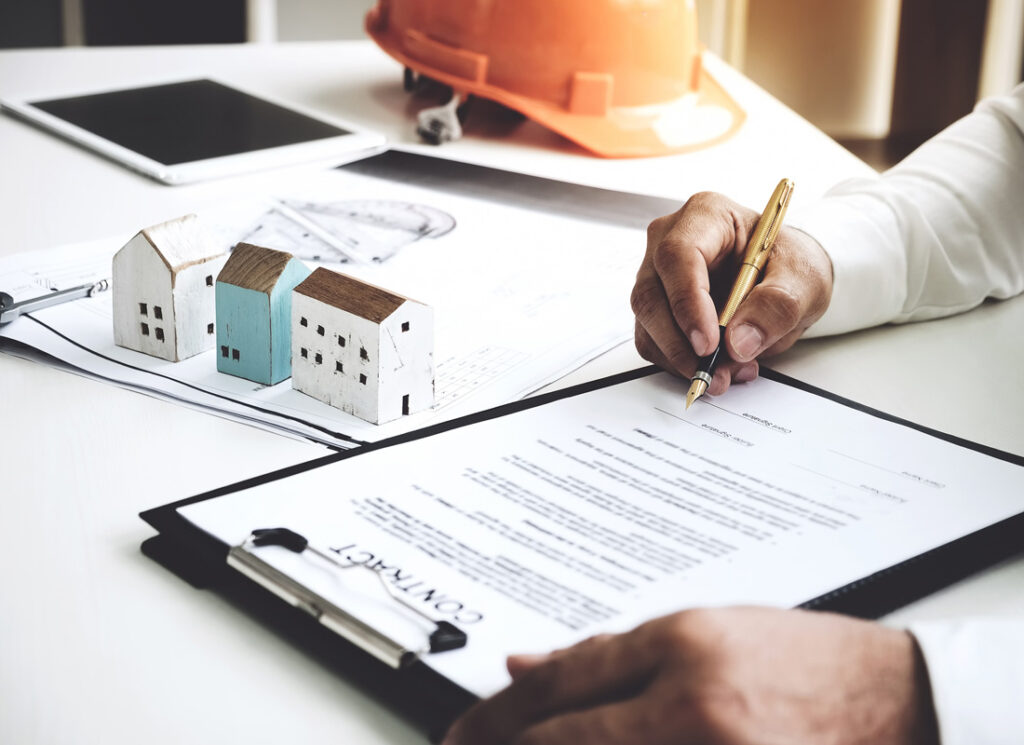 person signing document on clipboard