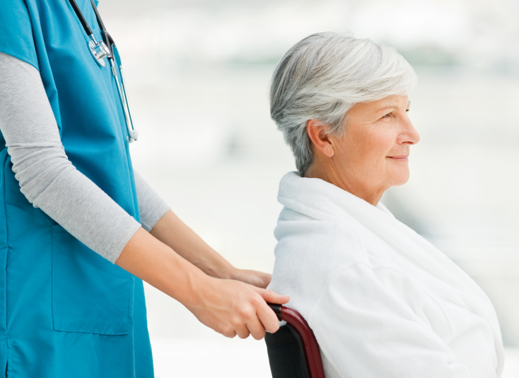 nurse pushing woman in wheelchair