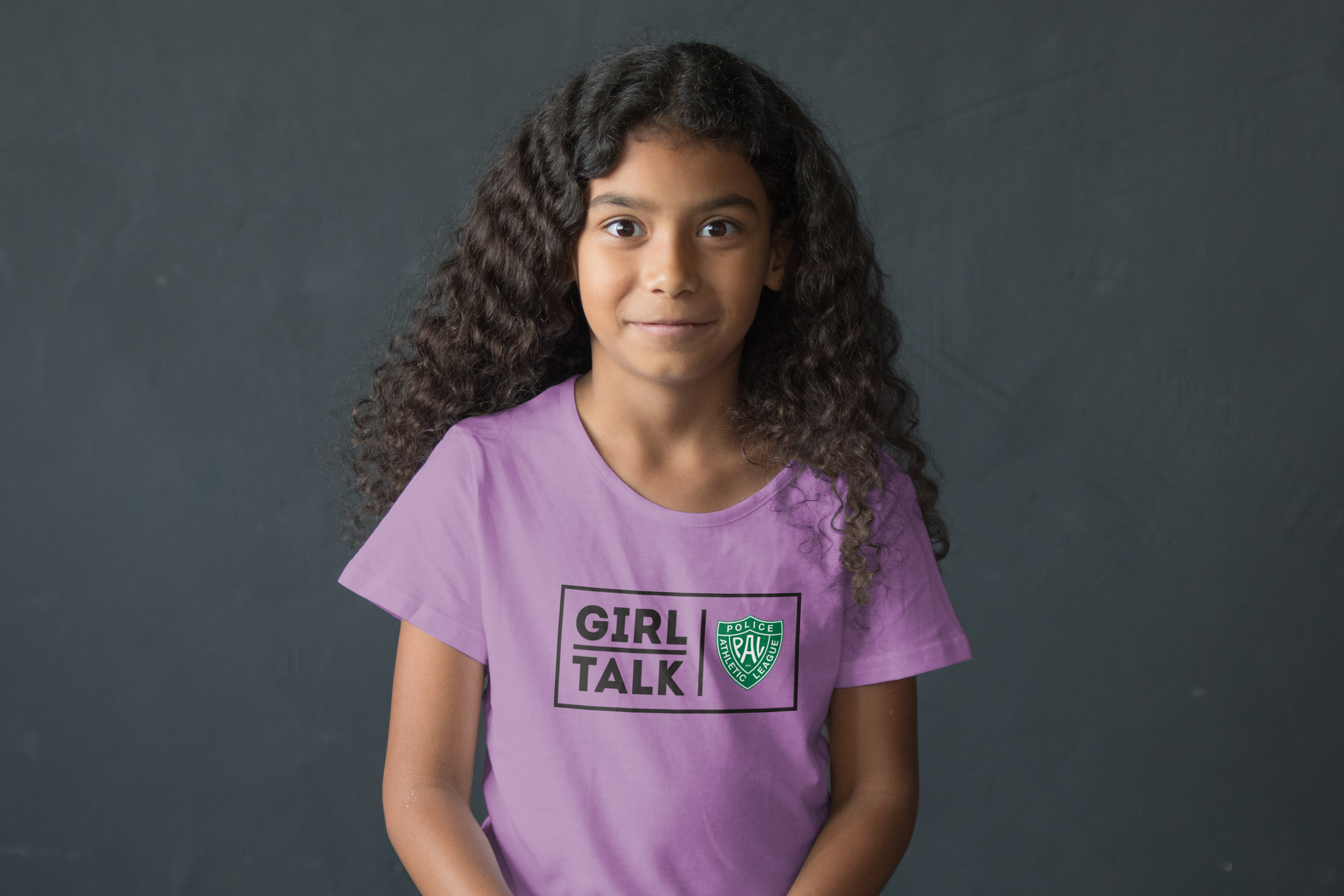 young girl wearing Police Athletic League "Girl Talk" purple t-shirt